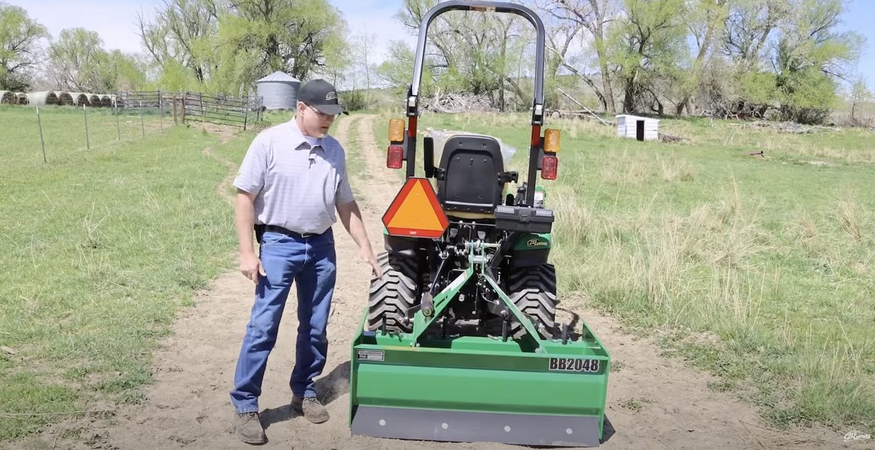 Neil Motley, a 21st Century Equipment employee, showcasing a John Deere tractor.